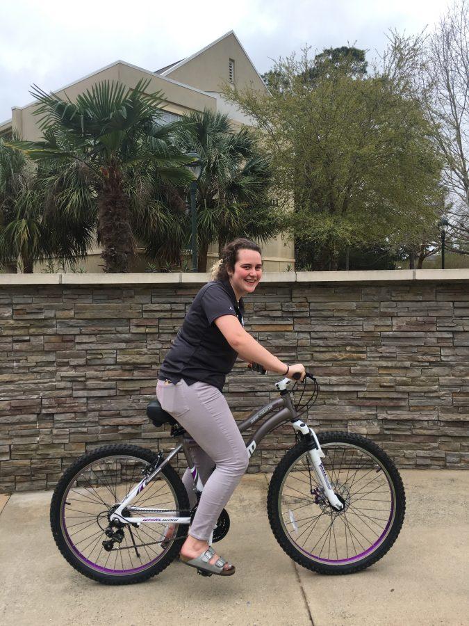 Sophomore Betsy Blumenfeld rides the bicycle she won in the raffle.