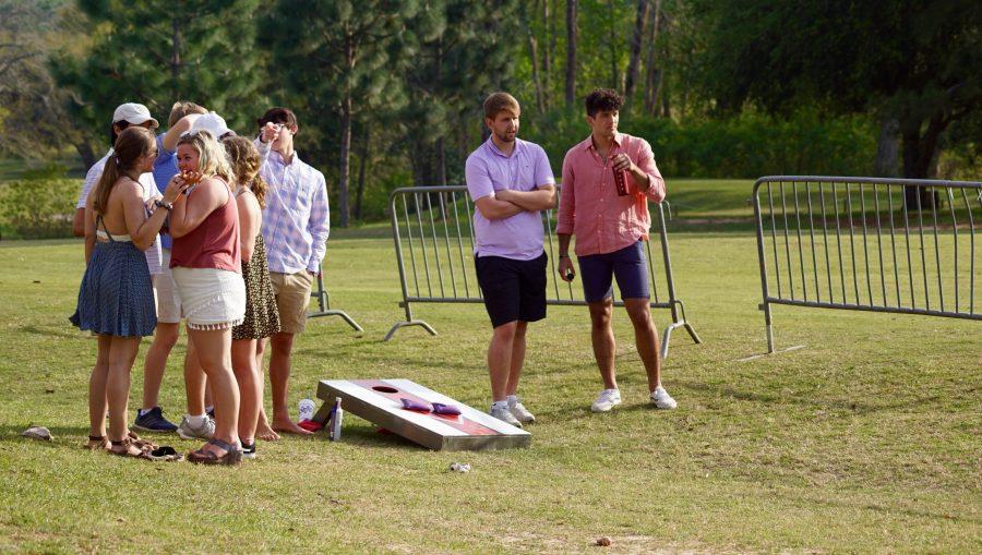 Students play cornhole and socialize.