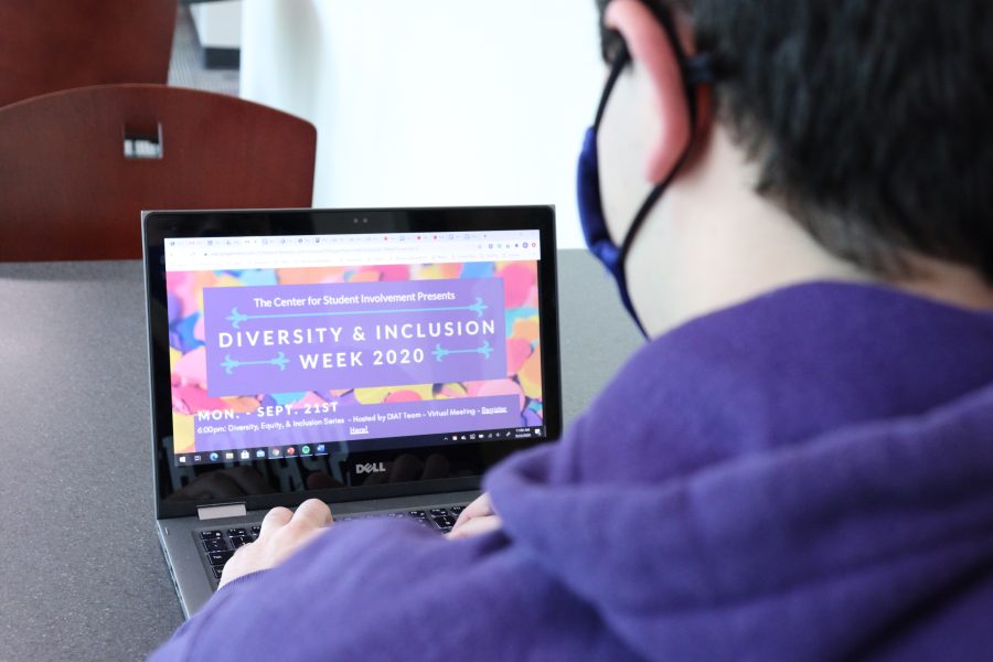 Student looks at Diversity & Inclusion Week flyer.