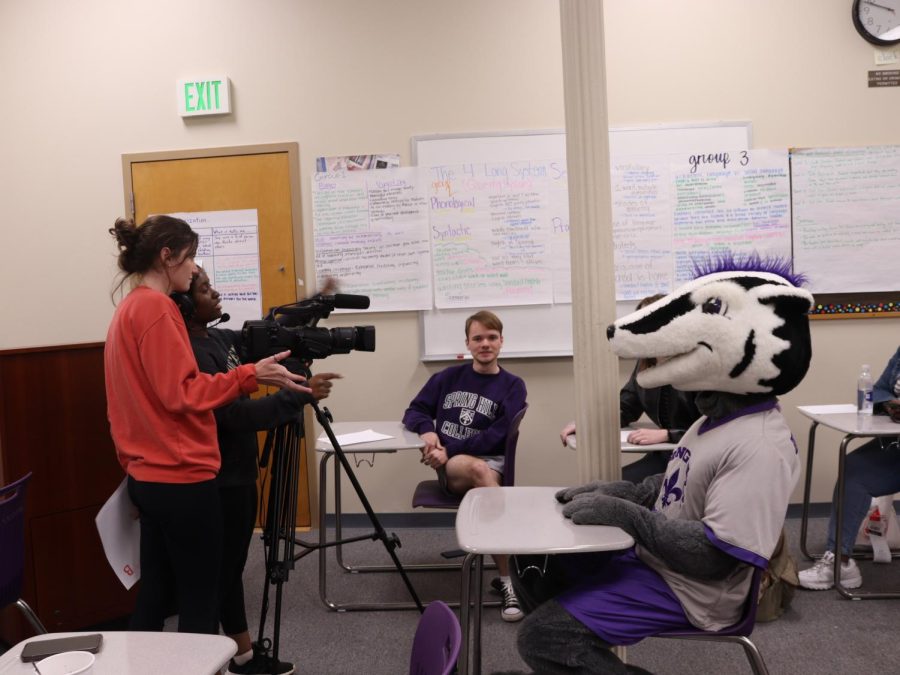 Members of the film club directing Beaumont Badger in a scene for a new video project.