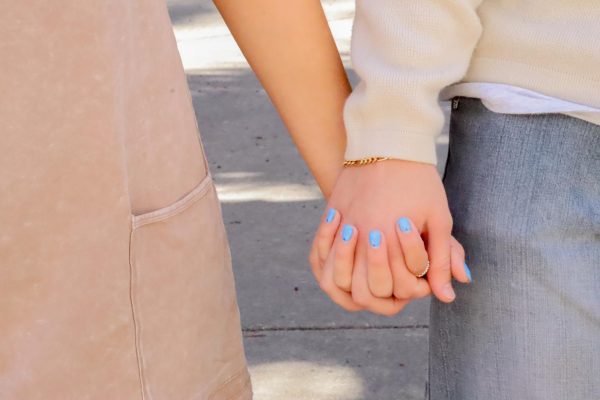 A couple on campus holding hands.