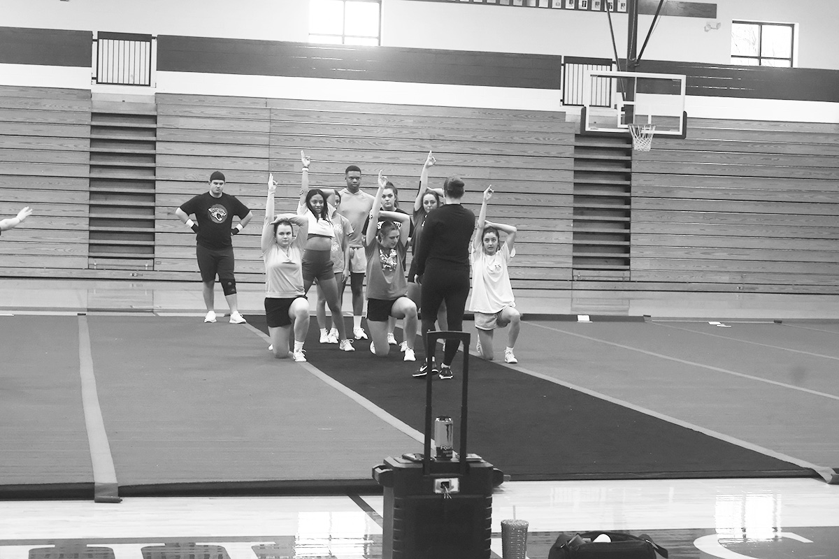 The cheerleading squad runs through a routine during practice