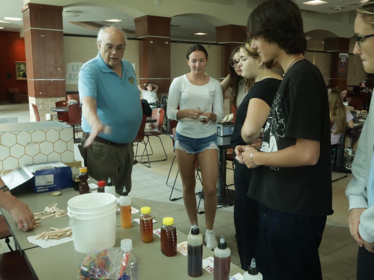 Honey Badgers faculty advisor, Dr. Don Culberson, teaching students about honey at the clubs honey-tasting event. 